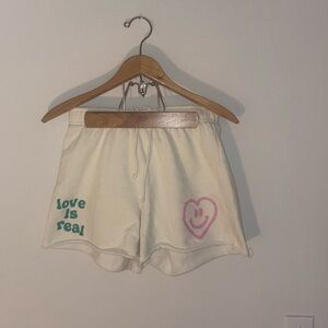 PacSun Cream Athletic Shorts with Pink Heart and Green Text